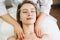 Facial massage beauty treatment. Close-up of a young woman s face lying on back, getting face lifting massage, pinch and