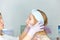 Facial skin care and protection. A young woman at a beauticians appointment. A specialist examines the face and skin