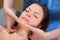 Facial tuina massge therapy on beutiful woman face