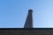 A Factory chimney against a blue sky at the abandonned blast furnace at Duisburg Landschafts Park Germany