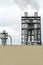 Factory chimneys against the gray autumn sky. Utopian landscape background. White toxic smoke is coming from a huge pipe.