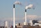 Factory chimneys with clouds and small windmills