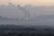 A factory emits smoke from its stacks, and Air pollution over the coal power plant Mae Moh Lampang in the morning with fog,