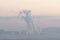 A factory emits smoke from its stacks, and Air pollution over the coal power plant Mae Moh Lampang in the morning with fog,