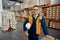 Factory employee looking at camera with safety work wear at industrial storehouse