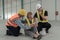 Factory engineer helping injured employee in the warehouse of a large industrial factory.