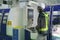 Factory foreman in uniform at cnc machine control panel at lathe factory