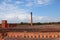 Factory with long bricks Chimney against blue sky