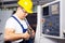 Factory man worker measuring steel detail with digital Vernier Caliper at workshop