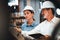 Factory manager inspecting industrial steel machinery. Exemplifying