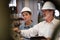 Factory manager inspecting industrial steel machinery. Exemplifying