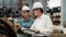 Factory manager inspecting industrial steel machinery. Pano Exemplifying