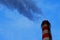 From the factory pipe high into the sky, dense and heavy clouds of industrial waste emissions enter the atmosphere