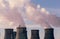 Factory pipes or Cooling towers of nuclear power plant with steam. Environmental
