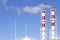 Factory plant smoke stack over blue sky background. Thermal condensing power plant. Energy generation and air environment pollutio