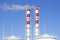 Factory plant smoke stack over blue sky background. Thermal condensing power plant. Energy generation and air environment pollutio