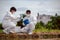 Factory scientists or biologists wear protective clothing while Collecting water samples in natural water sources near farmland.