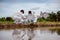 Factory scientists or biologists wear protective clothing while Collecting water samples in natural water sources near farmland.