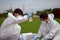 Factory scientists or biologists wear protective clothing while Collecting water samples in natural water sources near farmland.