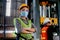 Factory woman worker or technician with hygienic mask stand with confident action with her co-worker  as background