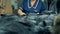 Factory worker brushes animal fur on a table, close up.