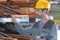 factory worker choosing welding fitting for industrial plumbing