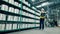 Factory worker with a laptop next to the shelves with fiberglass