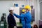 Factory worker man use infrared thermometer for measure and screening temperature of other co-workers in industrial workplace.