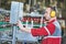 Factory worker operating conveyor with beer beverage bottles moving