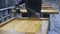 Factory worker spray painting furniture parts at an assembly line. painting stools, close-up