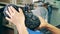 Factory worker is stitching a boot with a sewing machine