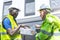 Factory worker technician engineer men showing and checking solar cell panel for sustainable technology with working suit and