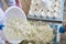 Factory workers fill molds for production of soft cheese