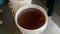 Factory workers filling out pails with honey