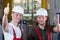 Factory workers giving thumbs up sign