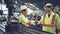 Factory workers handshake with team member in the factory