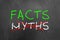 Facts and crossed myths text on blackboard or chalkboard