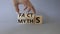 Facts vs Myths symbol. Businessman Hand turns cubes and changes word Myths to Facts. Beautiful grey background. Business and Facts