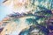 Faded coco palm leaf on blue sky background. Tropical nature vintage digital illustration. Exotic island landscape.