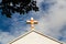 Faded cross on church roof