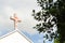 Faded cross on church roof