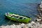 Faded green yellow motor power boat parked at Satpara Lake Pakistan