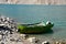 Faded green yellow motor power boat parked at Satpara Lake Pakistan