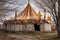 faded, peeling circus tent in disrepair
