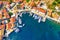 FAerial drone view of Fiscardo village port with luxury boats and yachts on Kefalonia island, Greece