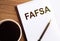 FAFSA text on notepad on wooden desk