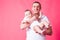 Faher and baby portrait on a pink background