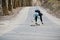 Fail falling from a skateboard. Street style arab man in eyeglasses with longboard longboarding down the road