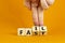 Fail fast symbol. Businessman turns wooden cubes with words `fail fast` on beautiful orange background, copy space. Business and