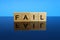 Fail word made of wooden letters on a mirror surface